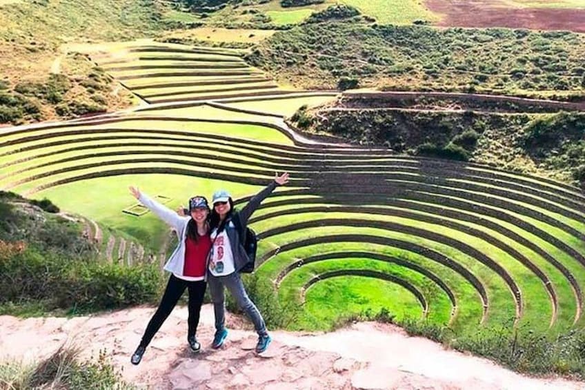 A terraced landscape with people standing on a path. 4