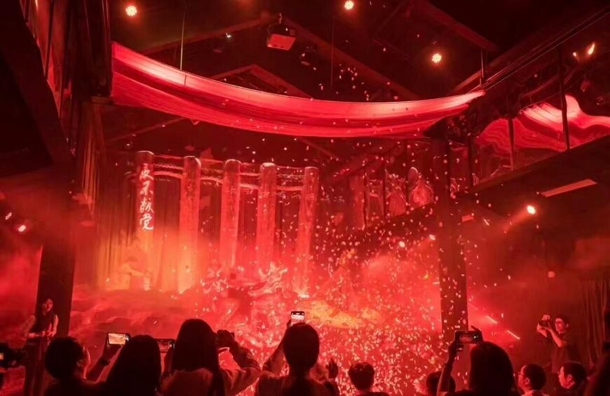 A concert with red lighting and smoke effects. 3