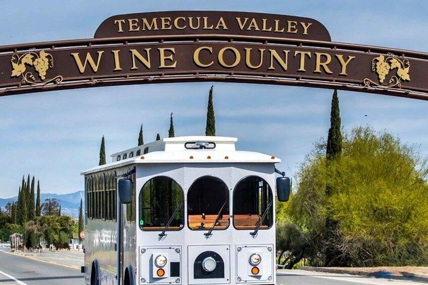 A bus with a sign reading 'Temecula Valley Wine Country' above it. 2