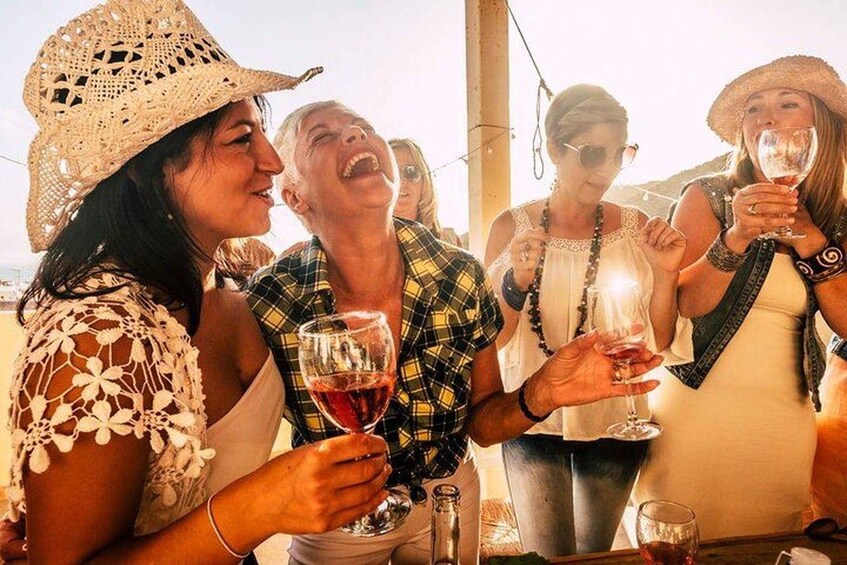 A group of people at a social gathering, holding wine glasses. 1