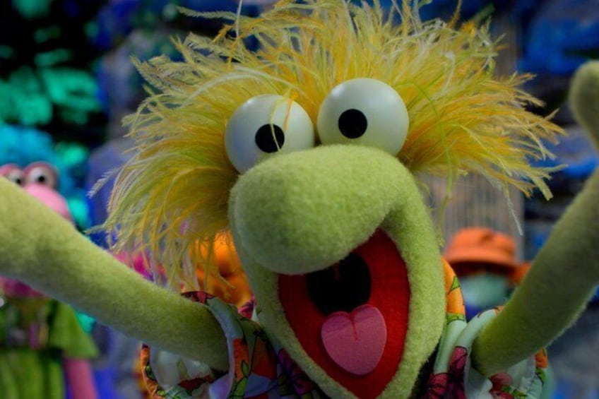 A puppet with a large head, big eyes, and a wide mouth. 4