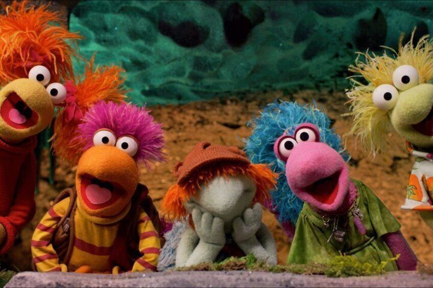 A group of colorful puppet characters with distinct features and expressions. 1