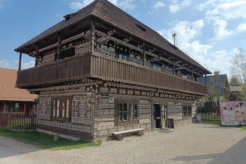 A traditional wooden building with intricate carvings and a balcony. 3