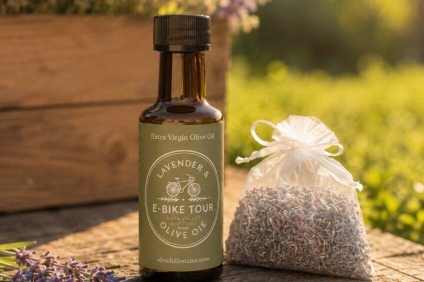 A bottle of Extra Virgin Olive Oil with a label, a small bag of dried lavender, and a wooden surface. 2