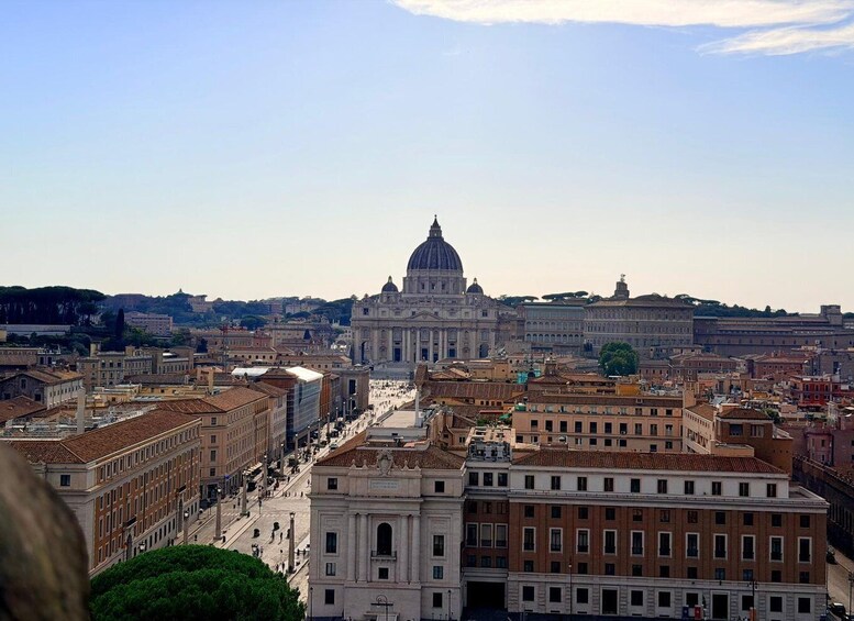 A cityscape with a prominent domed building in the center, surrounded by historic architecture and a clear sky. 5