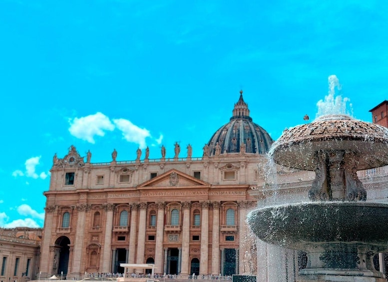 A historic building with a large dome and a fountain in the foreground. 4