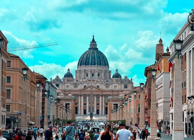 A bustling street with historic buildings, a prominent dome, and a crowd of people. 2