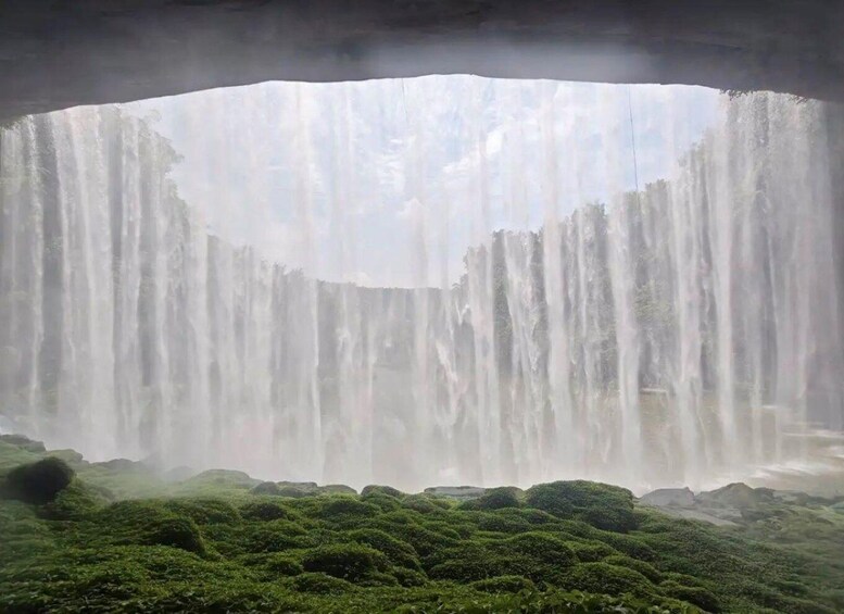 A waterfall cascading over mossy terrain. 2