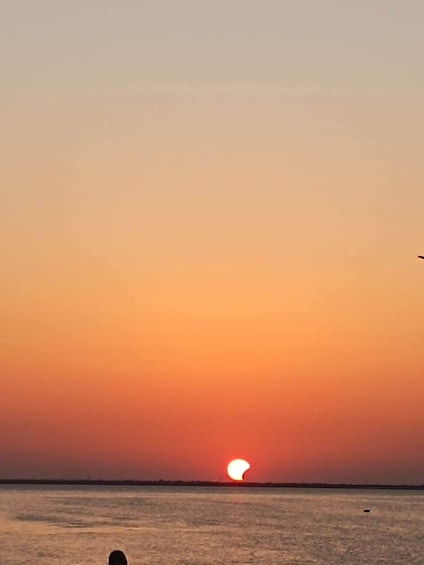 A sunset over a calm sea with a clear horizon. 3