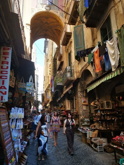A narrow street with shops and hanging laundry. 4