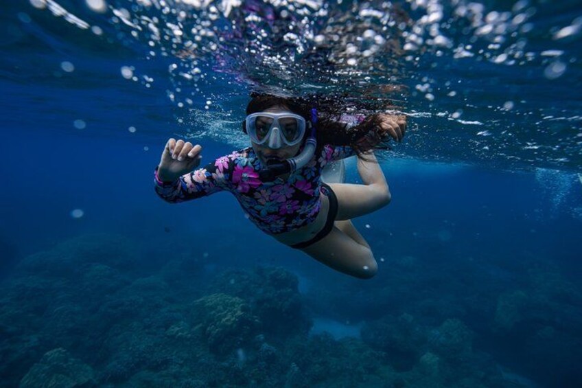 A person snorkeling underwater. 4
