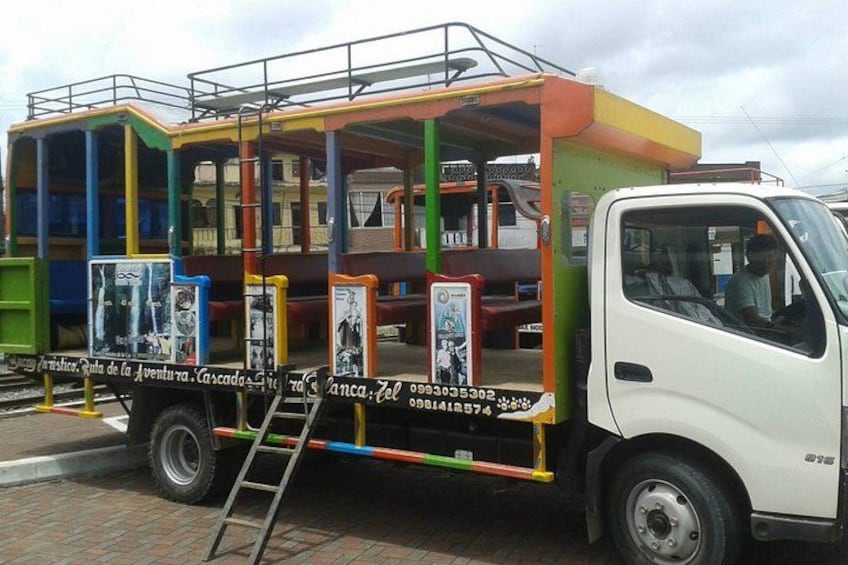 A colorful bus with advertisements and a ladder. 3
