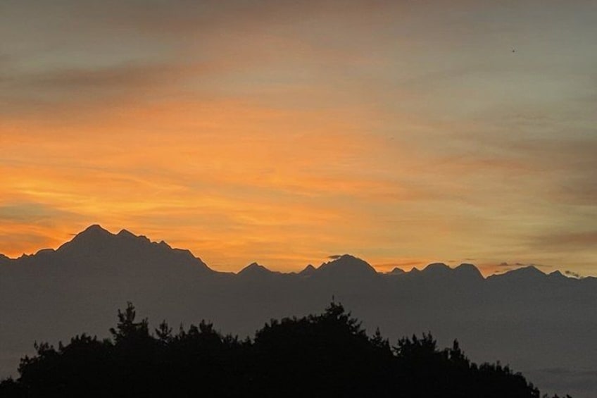 A mountain range silhouette against a sunset sky. 4
