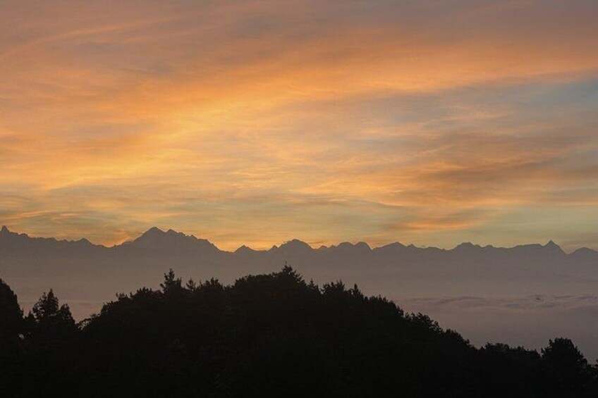 A mountain range silhouette against a sunset sky. 2