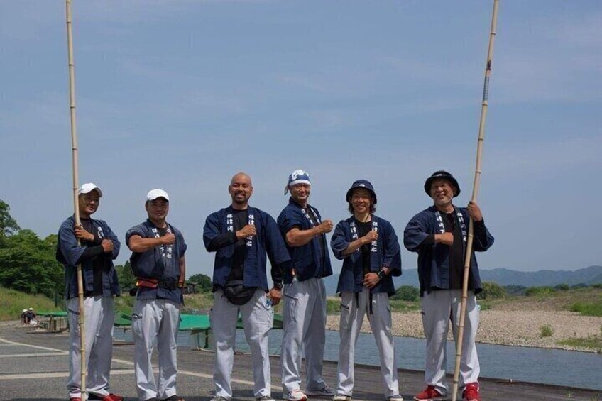 A group of people standing on a dock holding fishing rods. 2