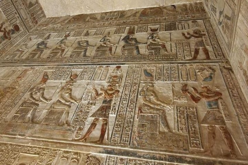 An ancient Egyptian wall with hieroglyphics and reliefs. 4