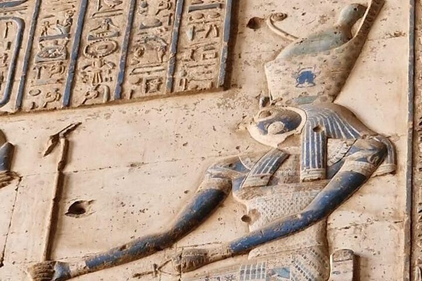 An ancient Egyptian relief with hieroglyphics and a depiction of a cobra. 5