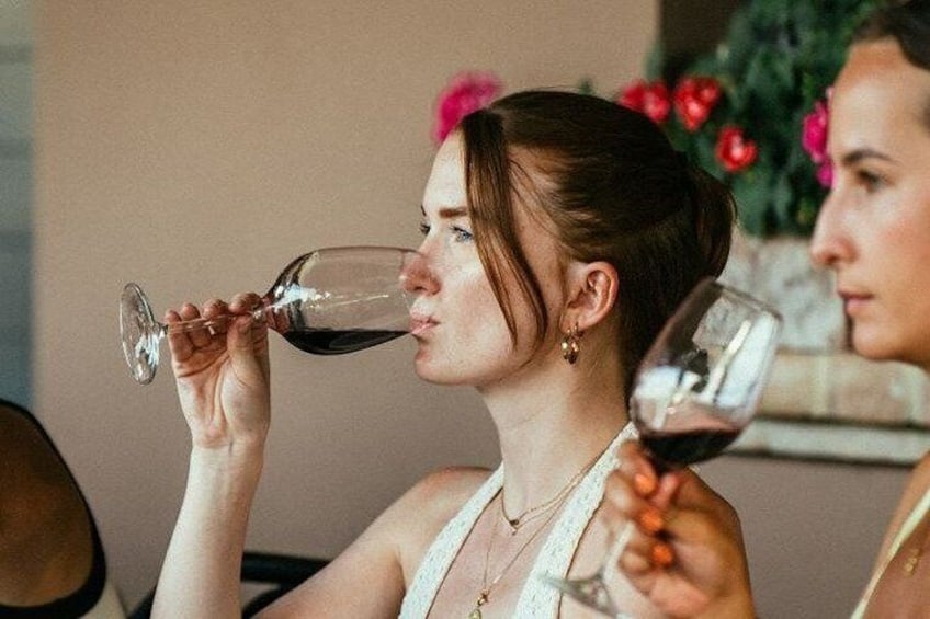A person holding a wine glass. 5