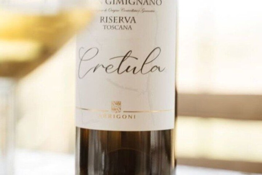 A bottle of Cretula wine with a label indicating it is a Riserva Toscana from Gimignano. 2