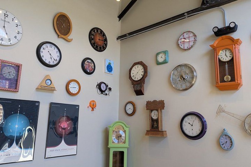 A variety of wall clocks of different shapes, sizes, and colors. 4