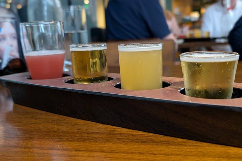 A tray with four glasses of beer. 3