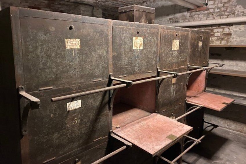 A row of metal bunk beds with metal frames and wooden slats. 4