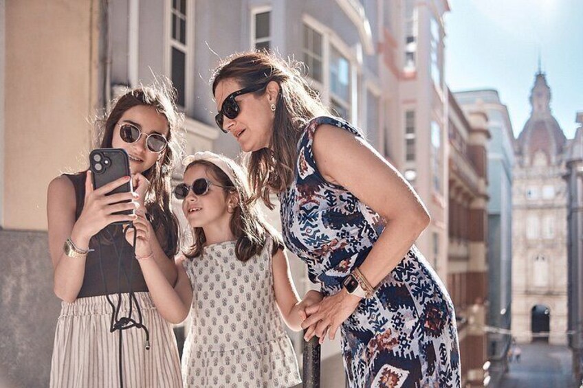 A group of people taking a selfie in an urban street with historic buildings in the background. 5