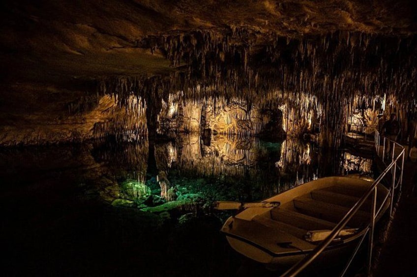 A cave with stalactites, a boat, and a staircase. 3