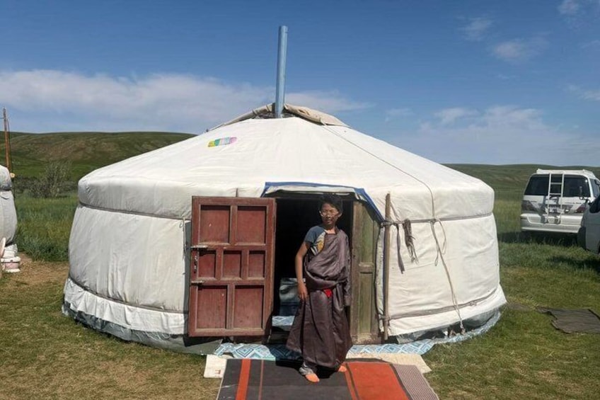 A yurt with a person standing in front of it. 5