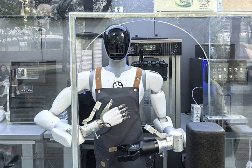 A humanoid robot with a helmet and overalls, standing in front of a vending machine. 4