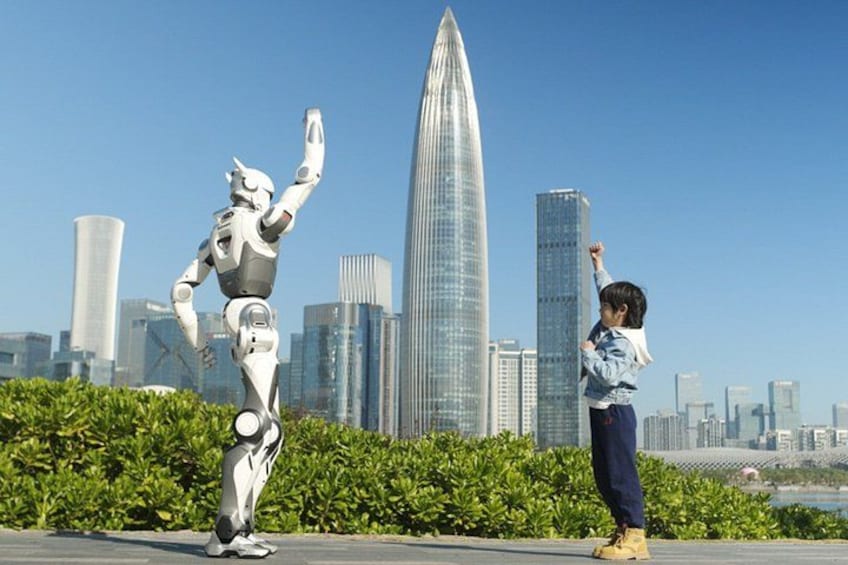 A person and a robot in an urban setting with modern skyscrapers in the background. 5