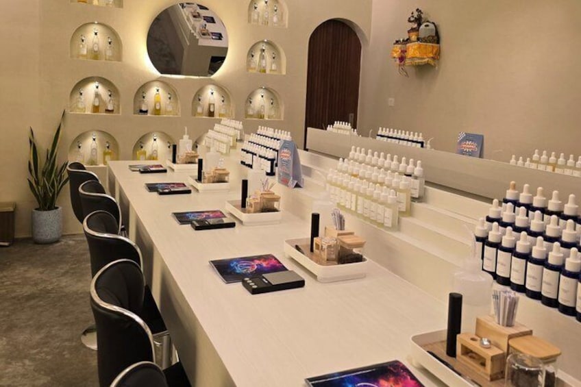 A salon interior with a long counter, chairs, and shelves of products. 4