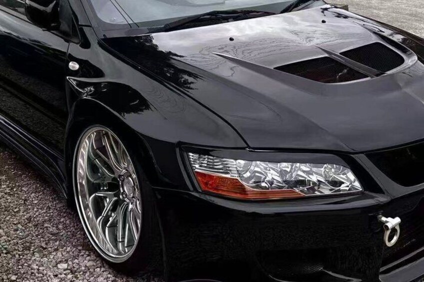 A black sports car with shiny chrome rims and a sleek design. 3