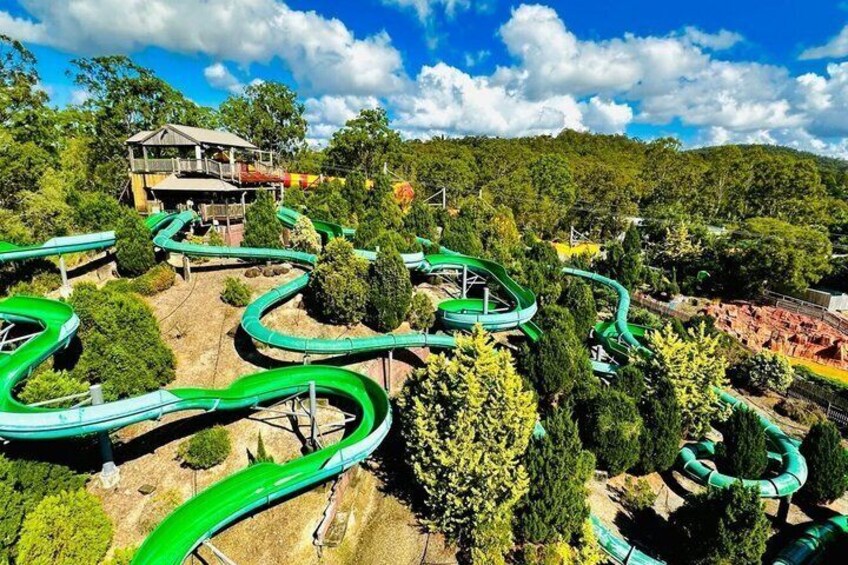 A water park with winding slides and a building in the background. 4