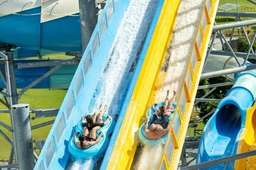 A water slide with two people sliding down. 3