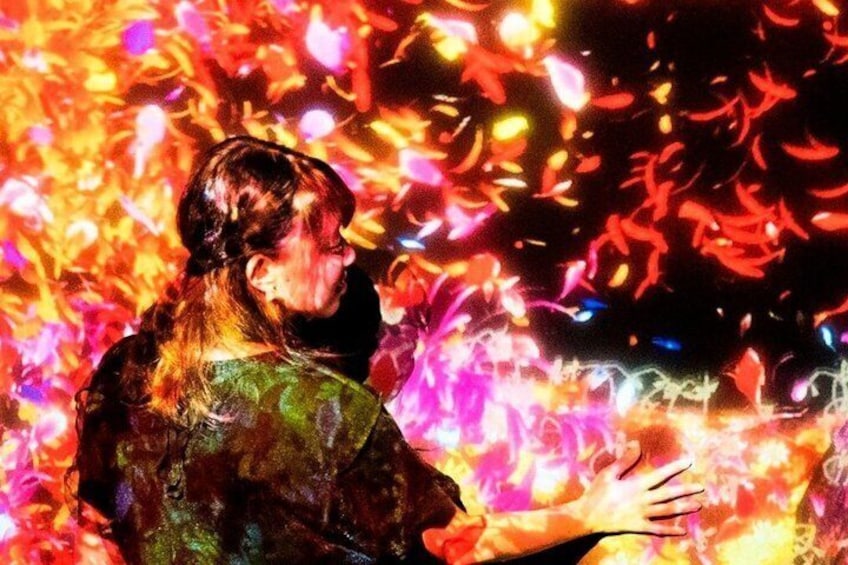 A person with a blurred face, wearing a patterned garment, holding a glowing object. 1