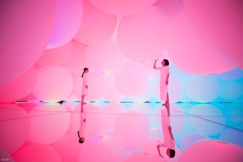 Two people in a reflective, colorful environment with large, soft shapes. 5