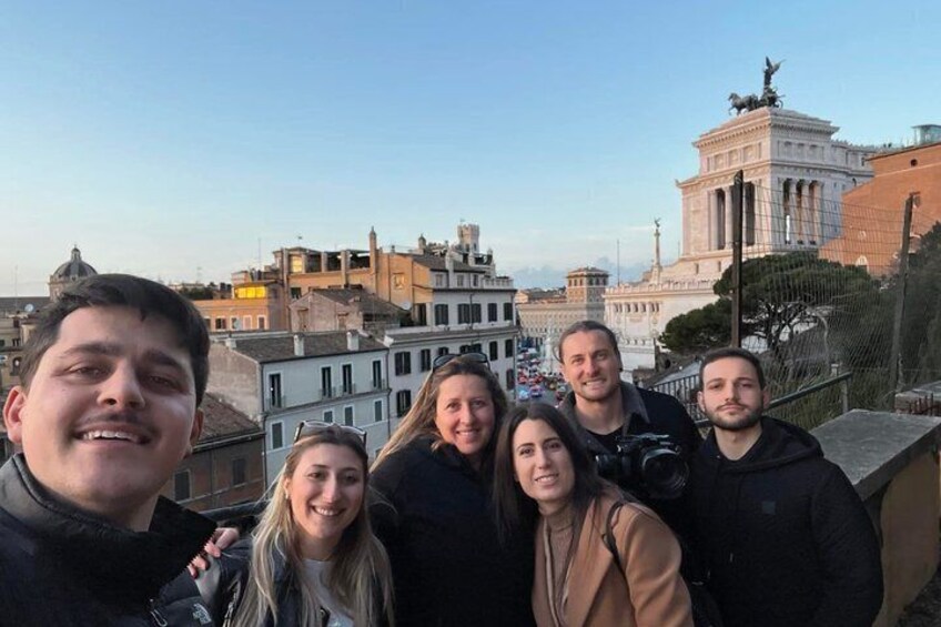 A group of people on a rooftop with a cityscape in the background. 5