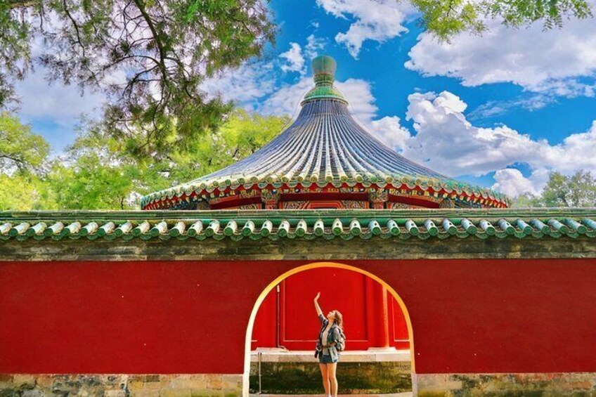 A traditional Chinese building with a curved roof and red walls. 1