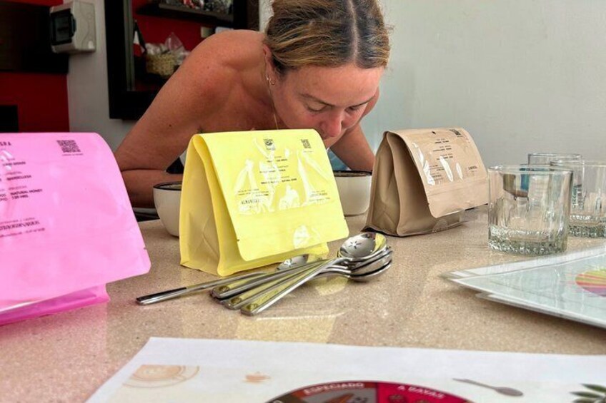 A person at a kitchen counter with a yellow bag, a brown paper bag, and a spoon. 4