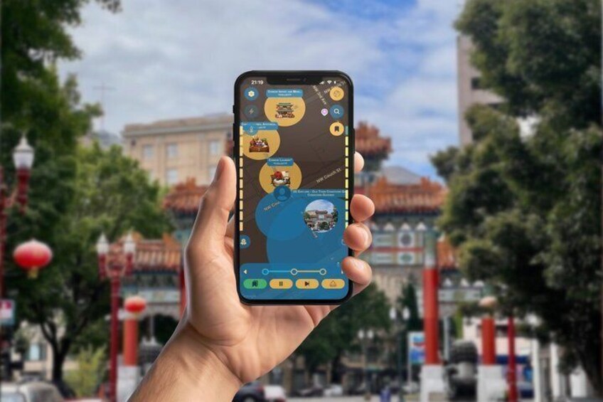 A hand holding a smartphone displaying a map with icons and a blue area highlighted. 4