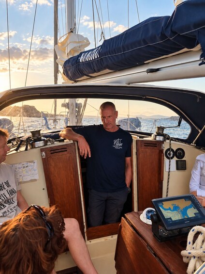 A man on a sailboat, a woman, and a dog. 3