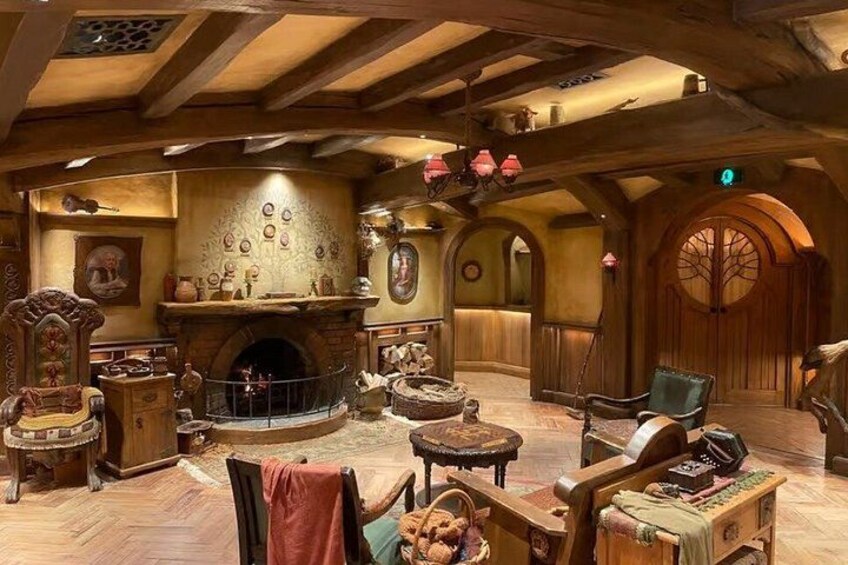 A rustic interior with a fireplace, wooden furniture, and decorative items. 5