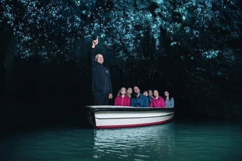 A boat with people on it, surrounded by water and trees. 1