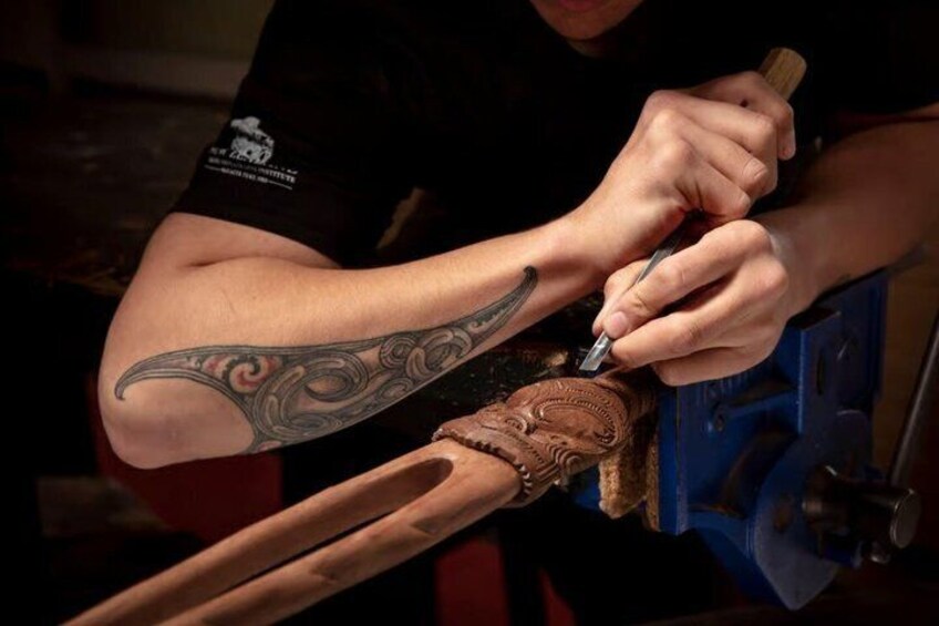 A person tattooing a design on a leather glove. 5