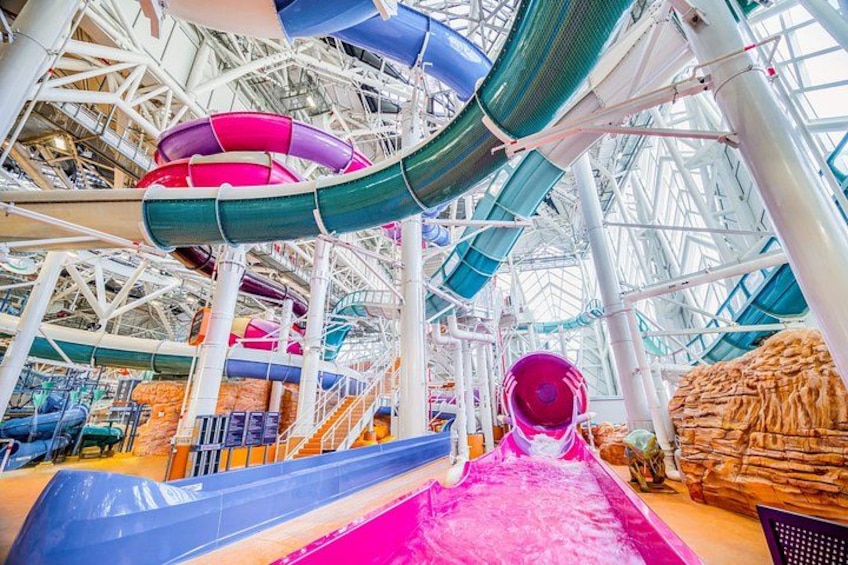 A water park with multiple slides and a large indoor structure. 5