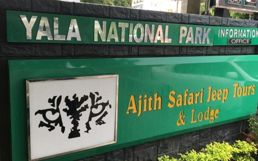A sign for Yala National Park Information Office and Ajith Safari Jeep Tours & Lodge. 4