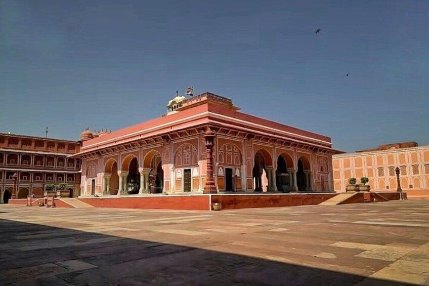 A large, ornate building with arches and a dome, surrounded by a courtyard. 4