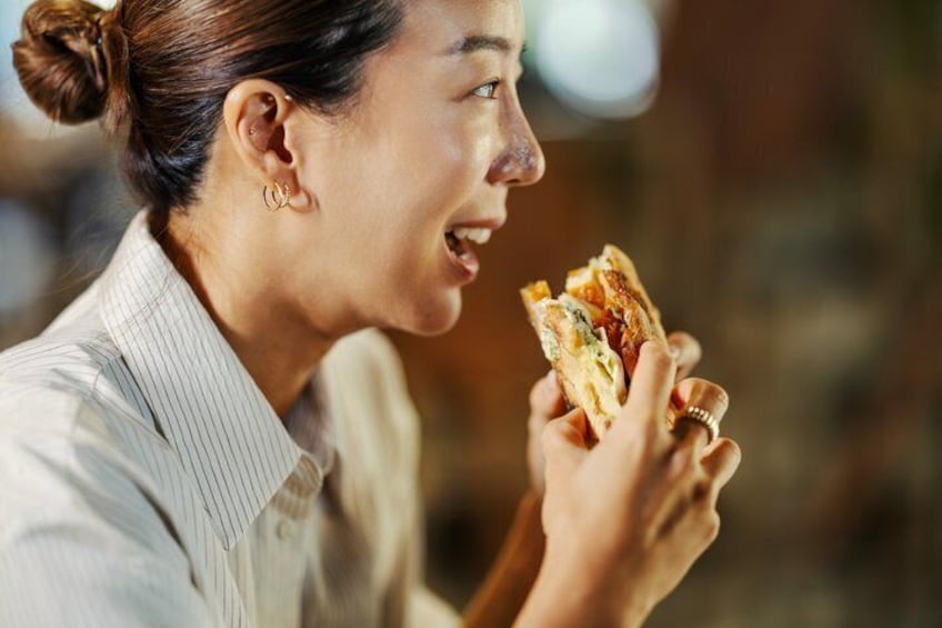 A person holding a sandwich. 5