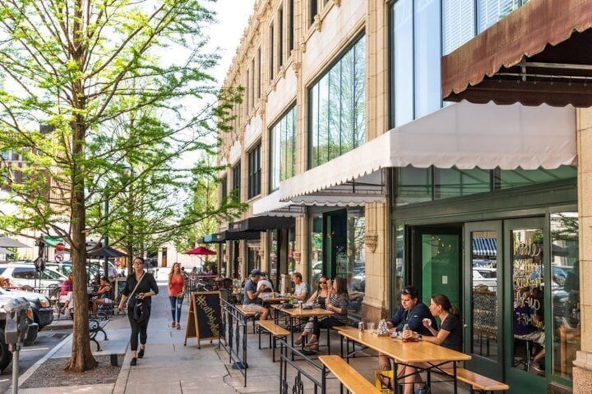 Outdoor seating at a cafe with people dining. 2